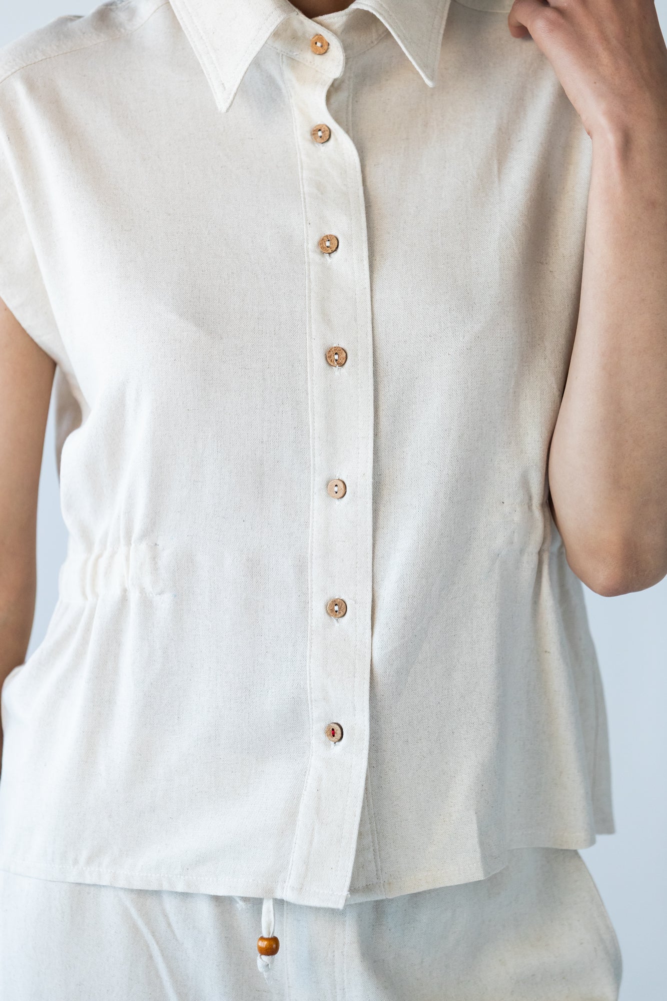Reese stone shirt, close up of button placket and elasticated waist