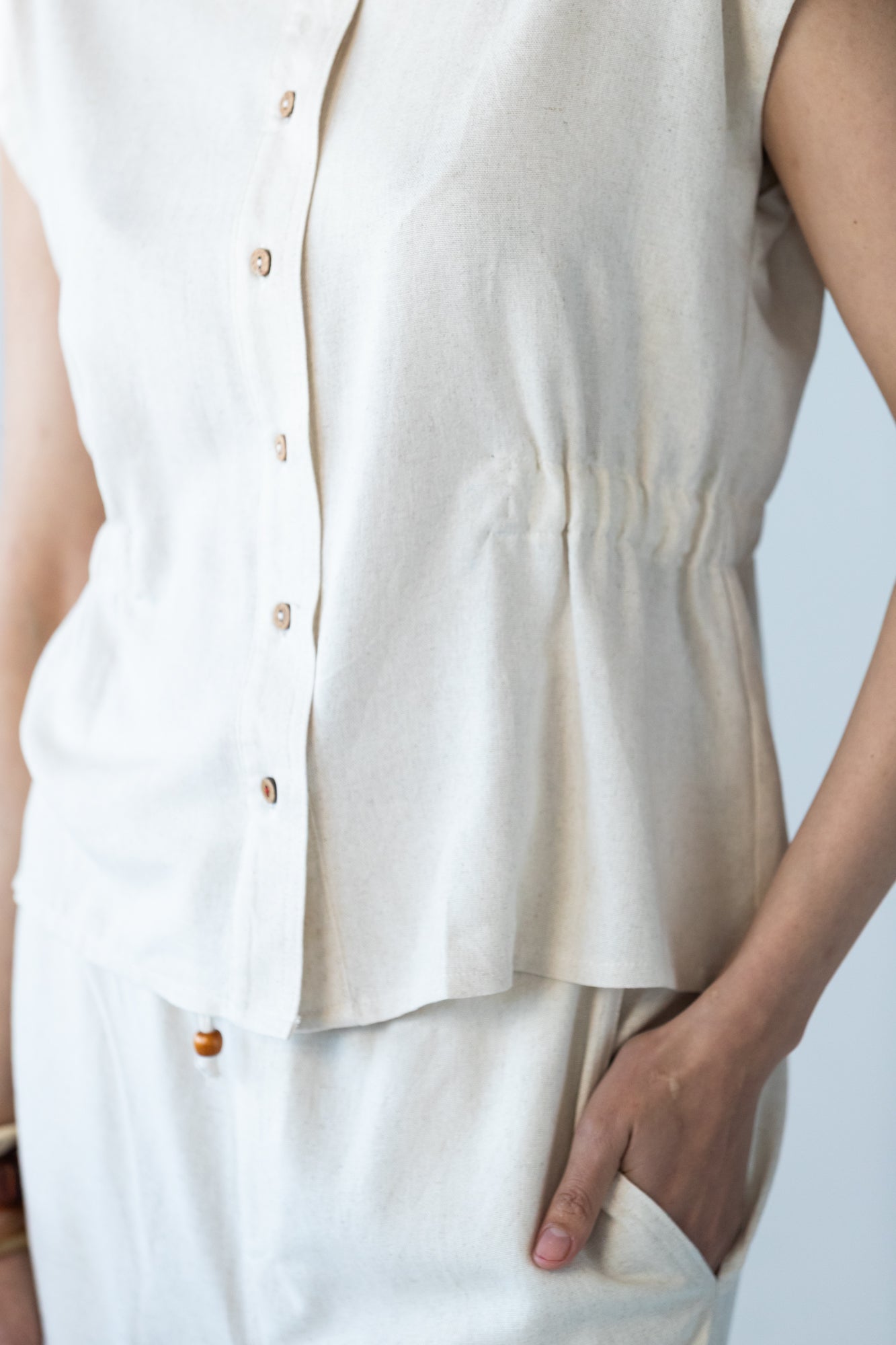 Reese stone shirt, close up of button placket and elasticated waist detail