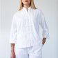 Kinsley white kaftan-style shirt, front view with hand in pocket