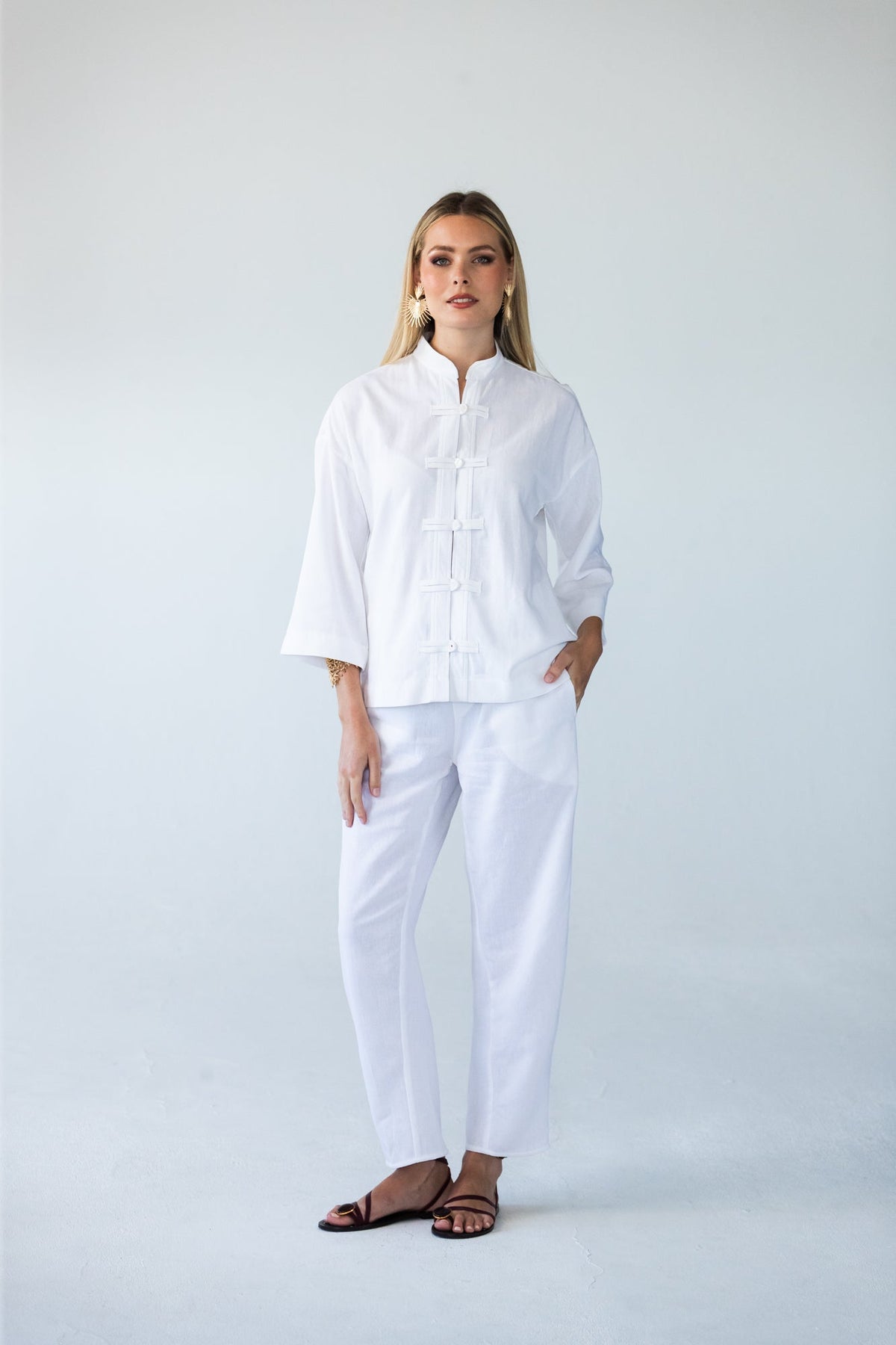 Parker white barrel pants, front view standing styled with white top