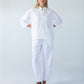 Parker white barrel pants, front view close up with hands on hips