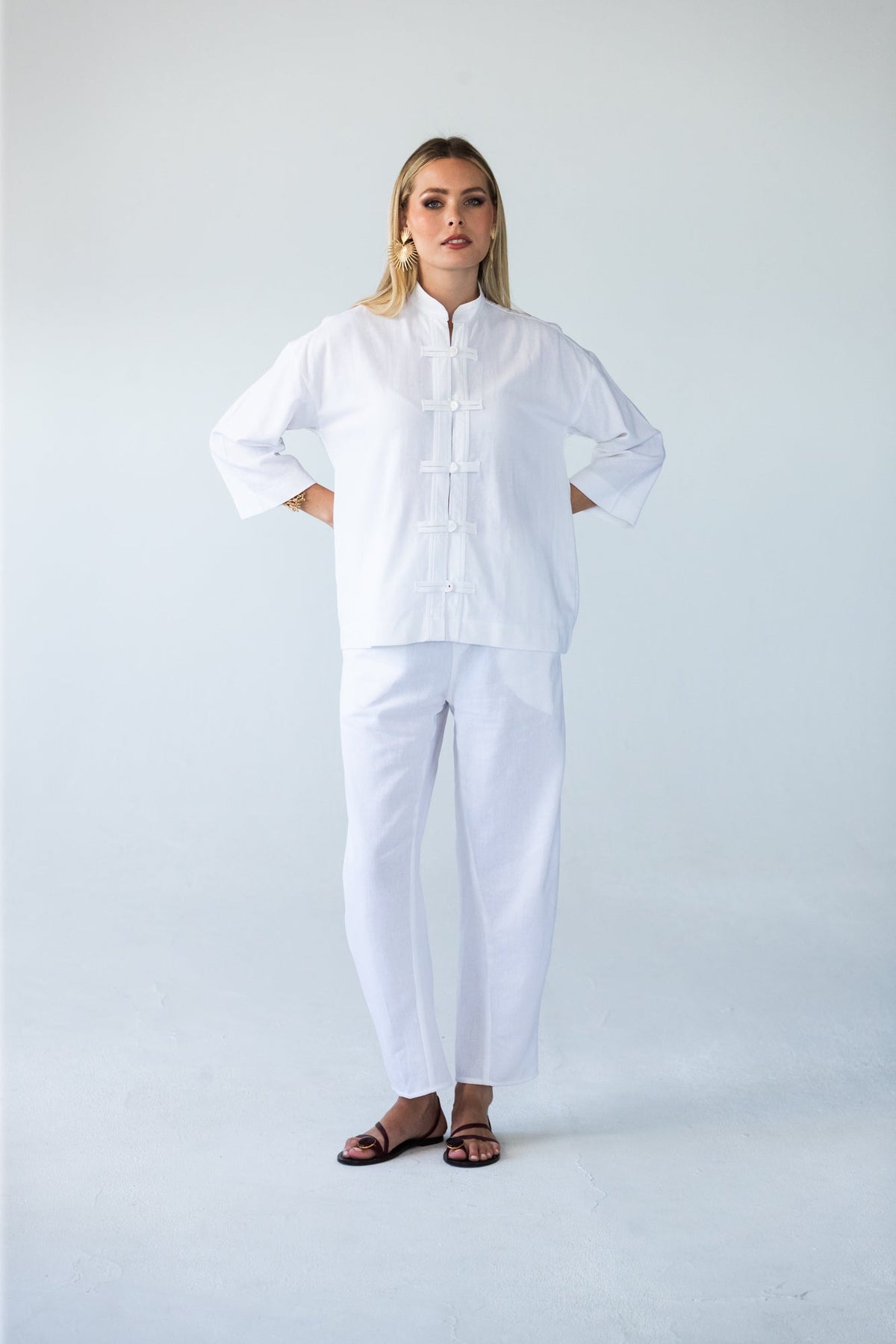 Parker white barrel pants, front view close up with hands on hips