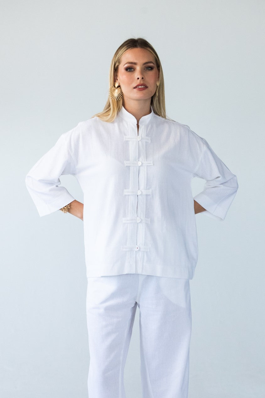 Kinsley white kaftan-style shirt, front view with hands on hips