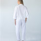 Parker white barrel pants, back view full length with hands on hips