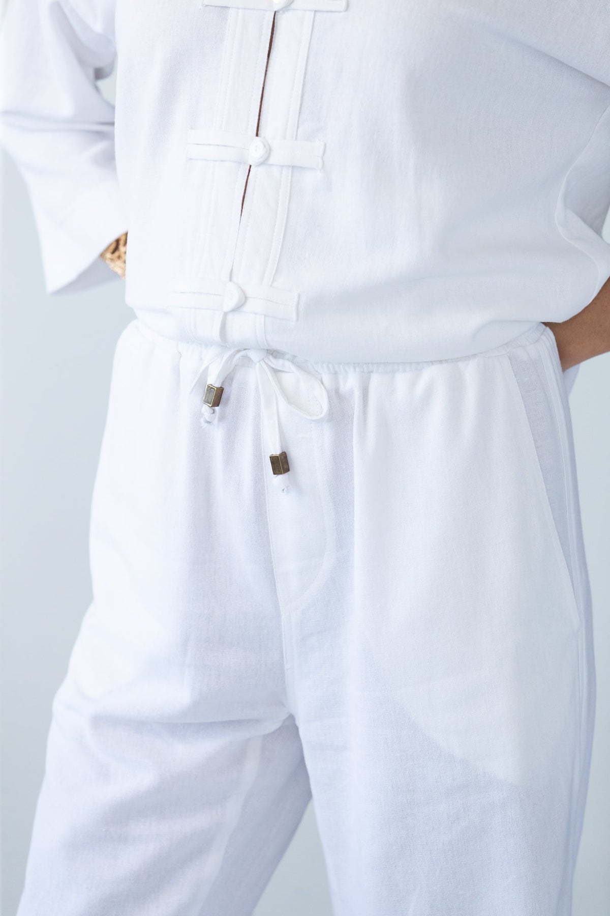Parker white barrel pants, close up of waistband, drawcord and toggle
