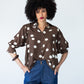 Harper 3/4 sleeve shirt in chocolate and cream polka dot, front view with hands in pockets