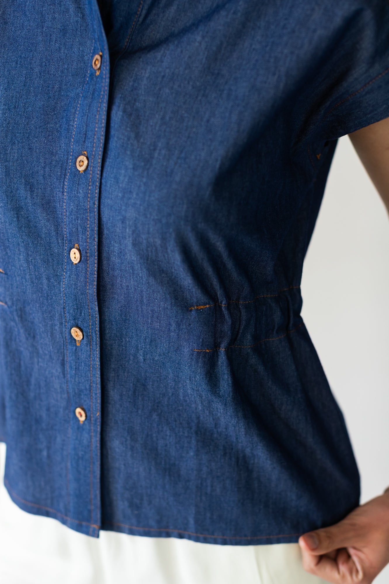 Reese denim shirt, close up of button placket and elasticated waist