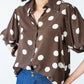 Harper polka dot shirt, front view showing collar, button front and red thread on last button