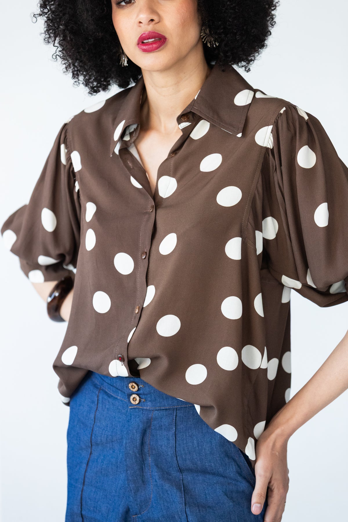 Harper polka dot shirt, front view showing collar, button front and red thread on last button