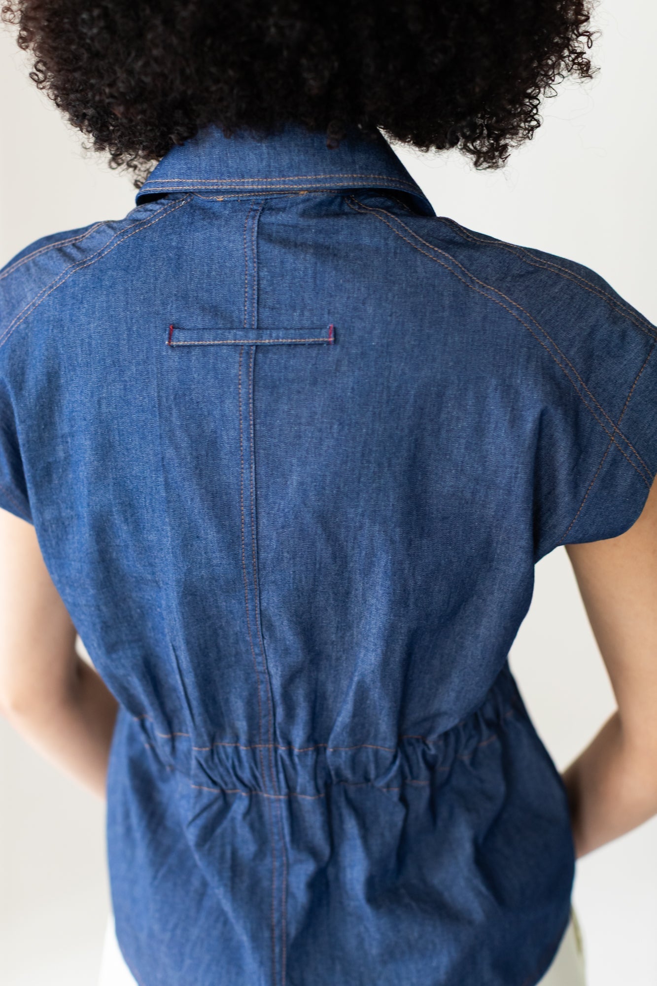 Reese denim shirt, back view showing loop tab and elasticated seam