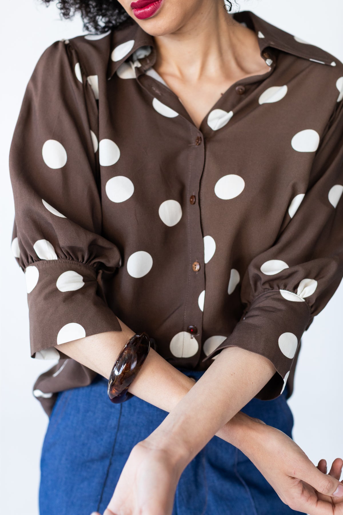 Harper polka dot shirt, front close-up with arms crossed showing cuffs and buttons