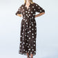Sloane polka dot dress, front view with hands on hips