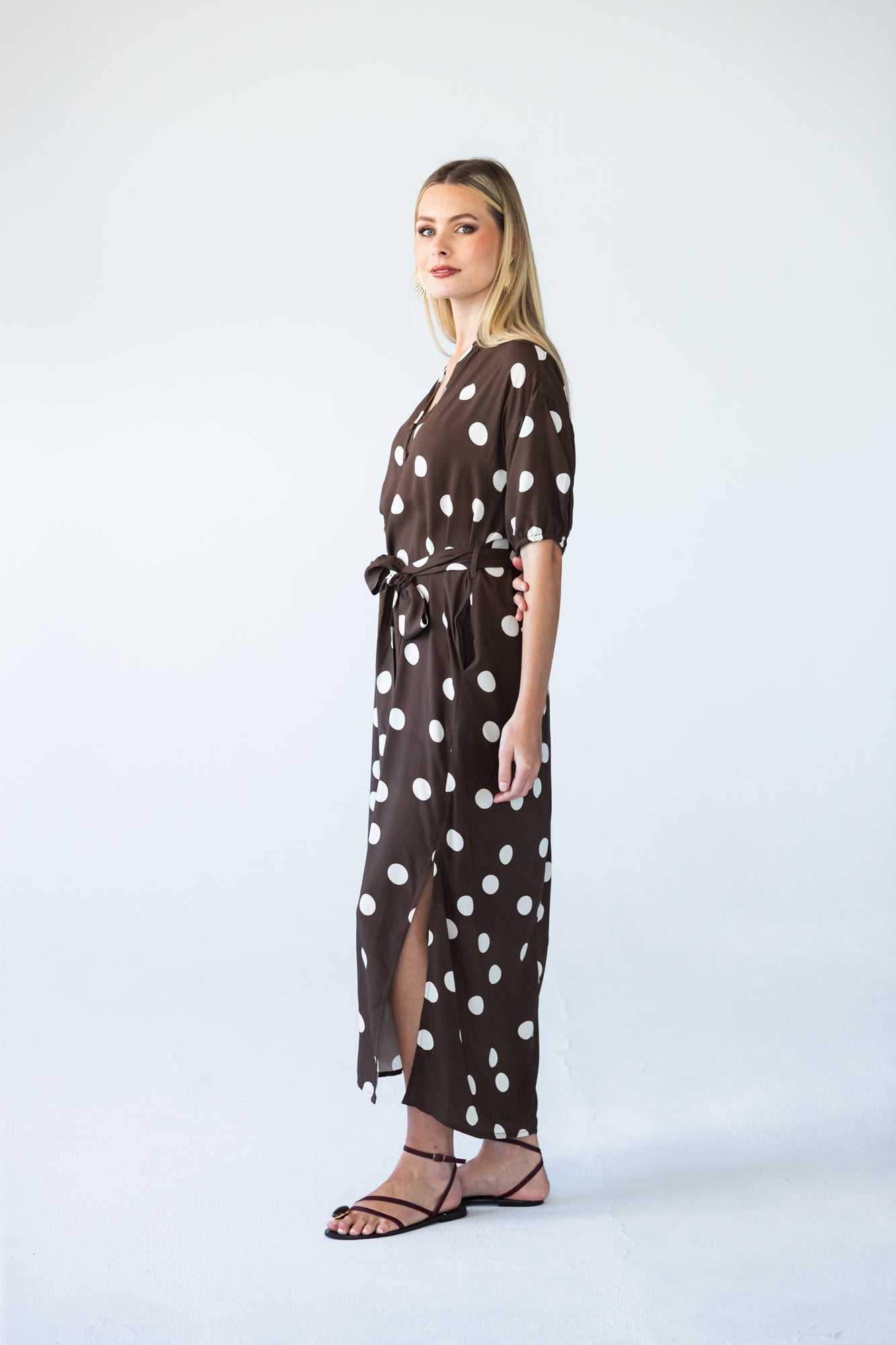 Sloane polka dot dress, side profile showing belt and side slit