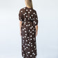 Sloane polka dot dress, back view with model looking over shoulder