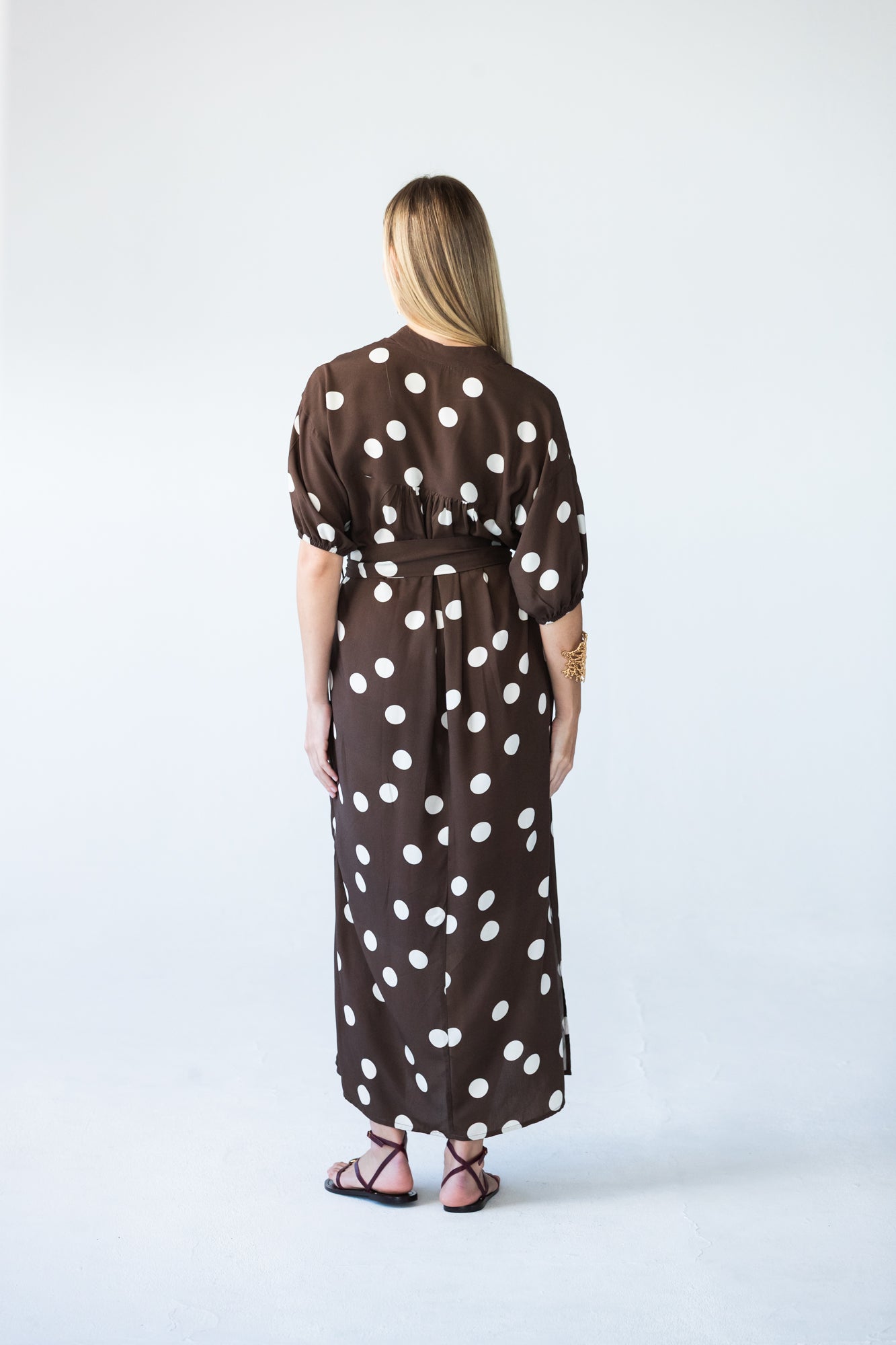 Sloane polka dot dress, back view with model looking over shoulder