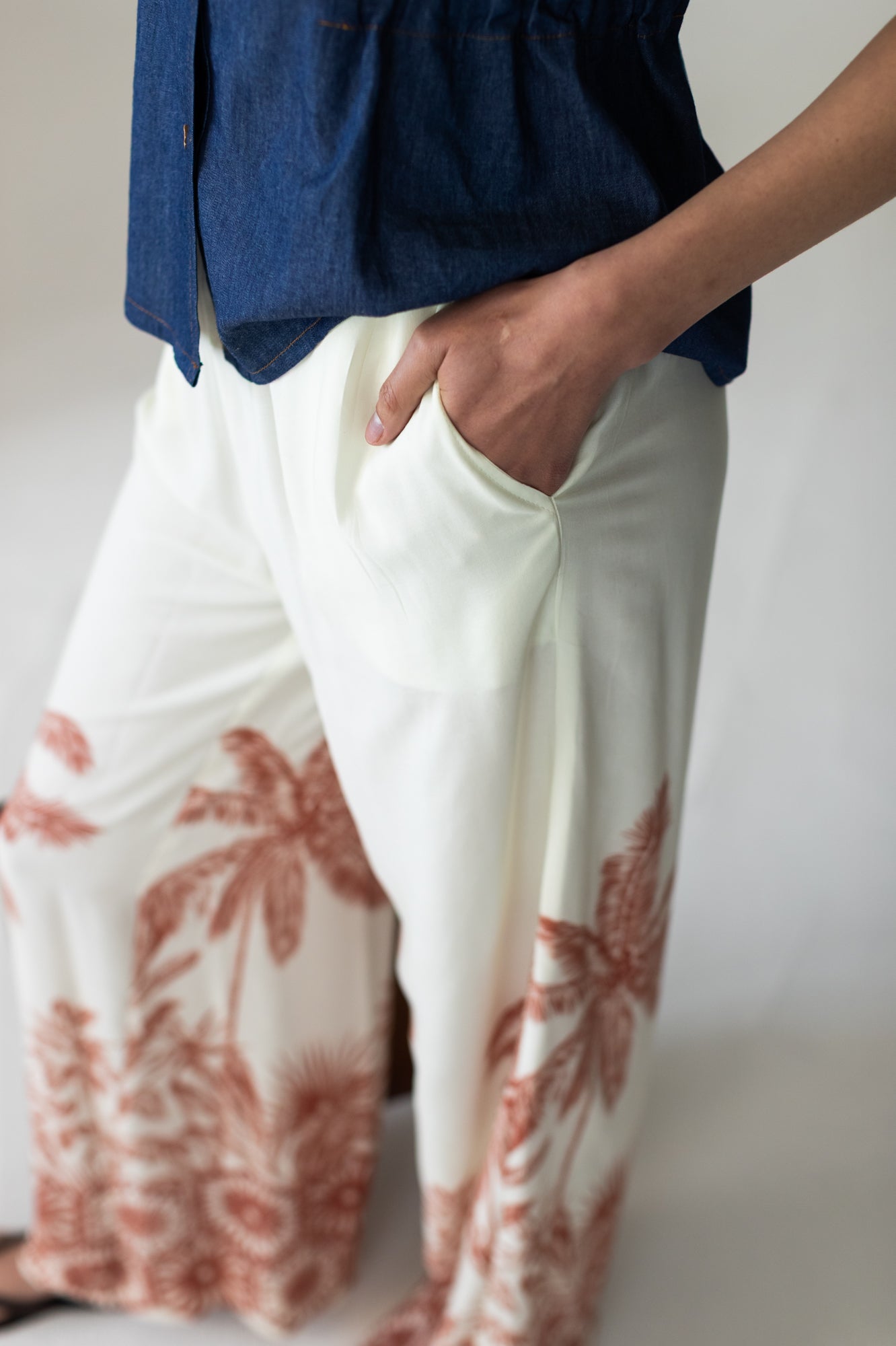 Sydney palm border wide leg pants, close up of waistband with hand in pocket