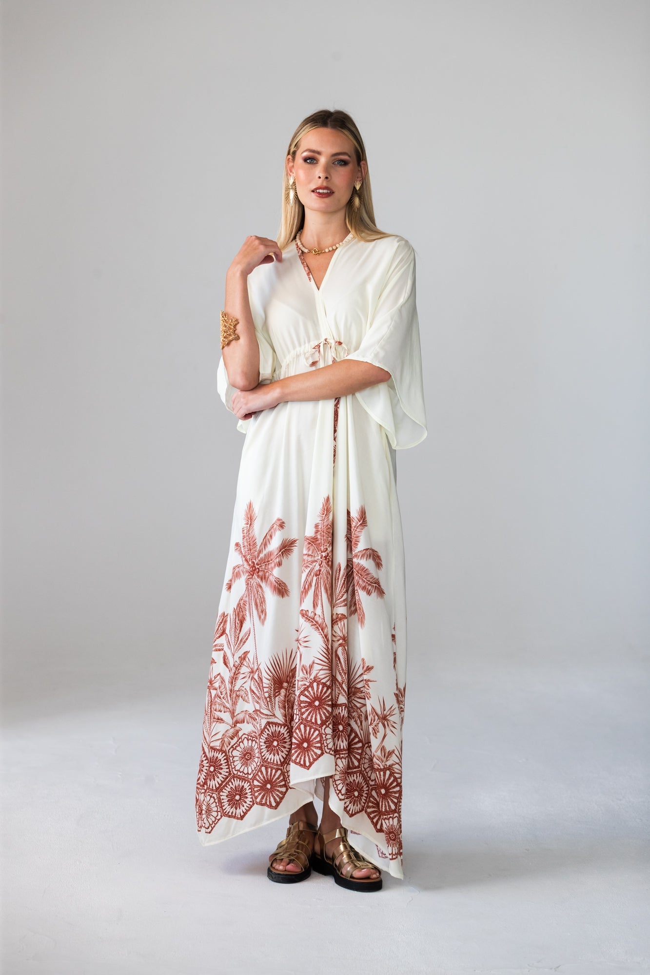 Georgia cream palm print kaftan, front view with arms crossed