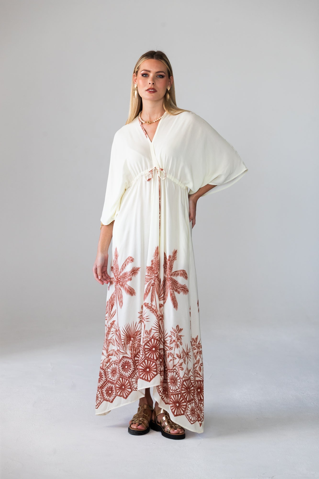 Georgia cream palm print kaftan, front view with hand on hip