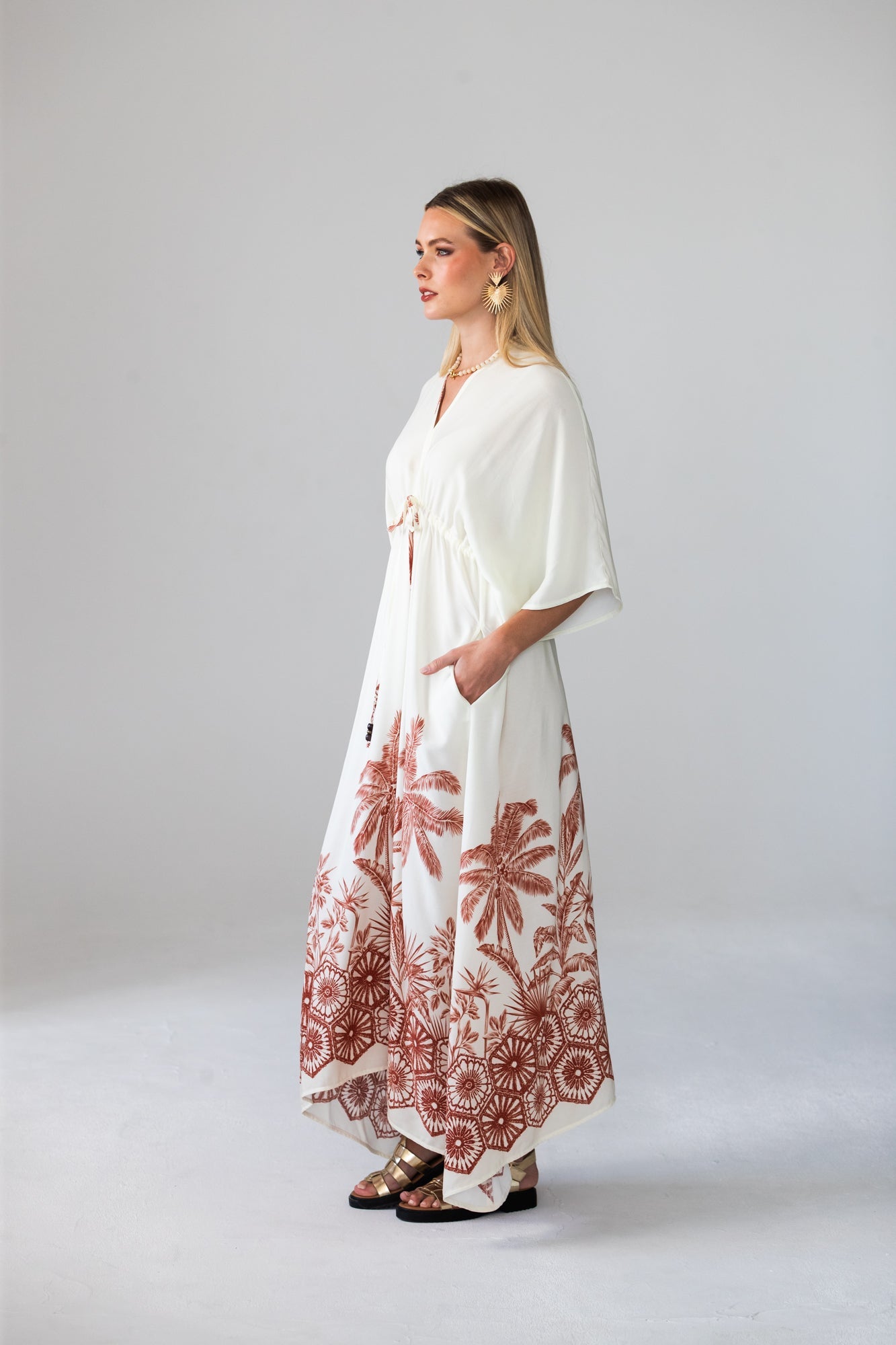 Georgia cream palm print kaftan, side profile with hand in pocket