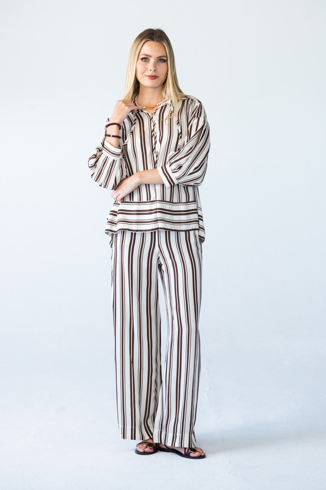 Sydney chocolate stripe wide leg pants, front view with arms crossed