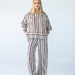 Sydney chocolate stripe wide leg pants, front view with hands on hips