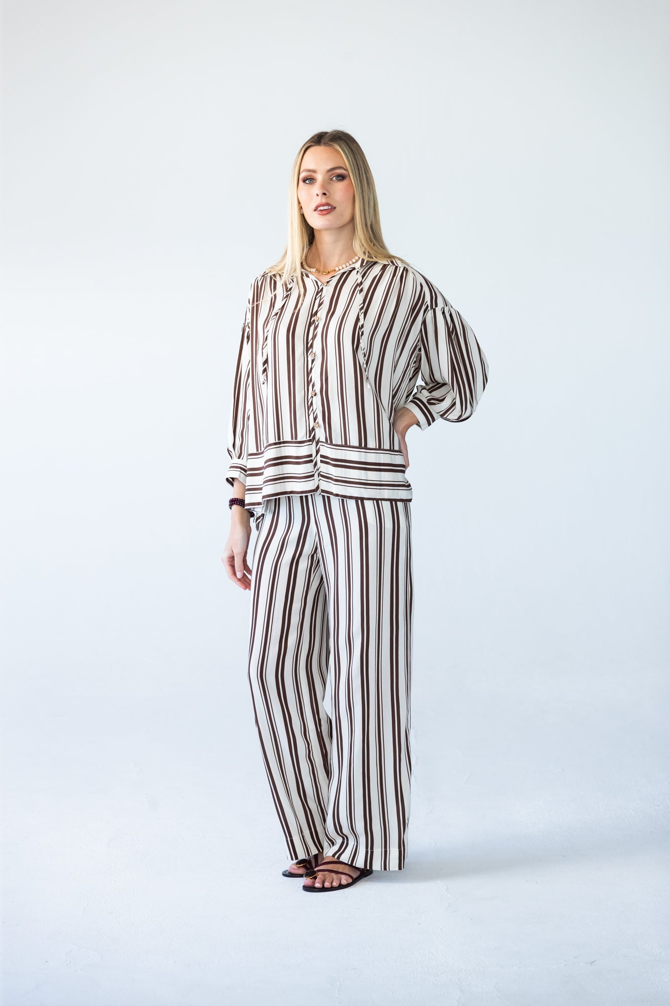 Sydney chocolate stripe wide leg pants, front view with hand on hip