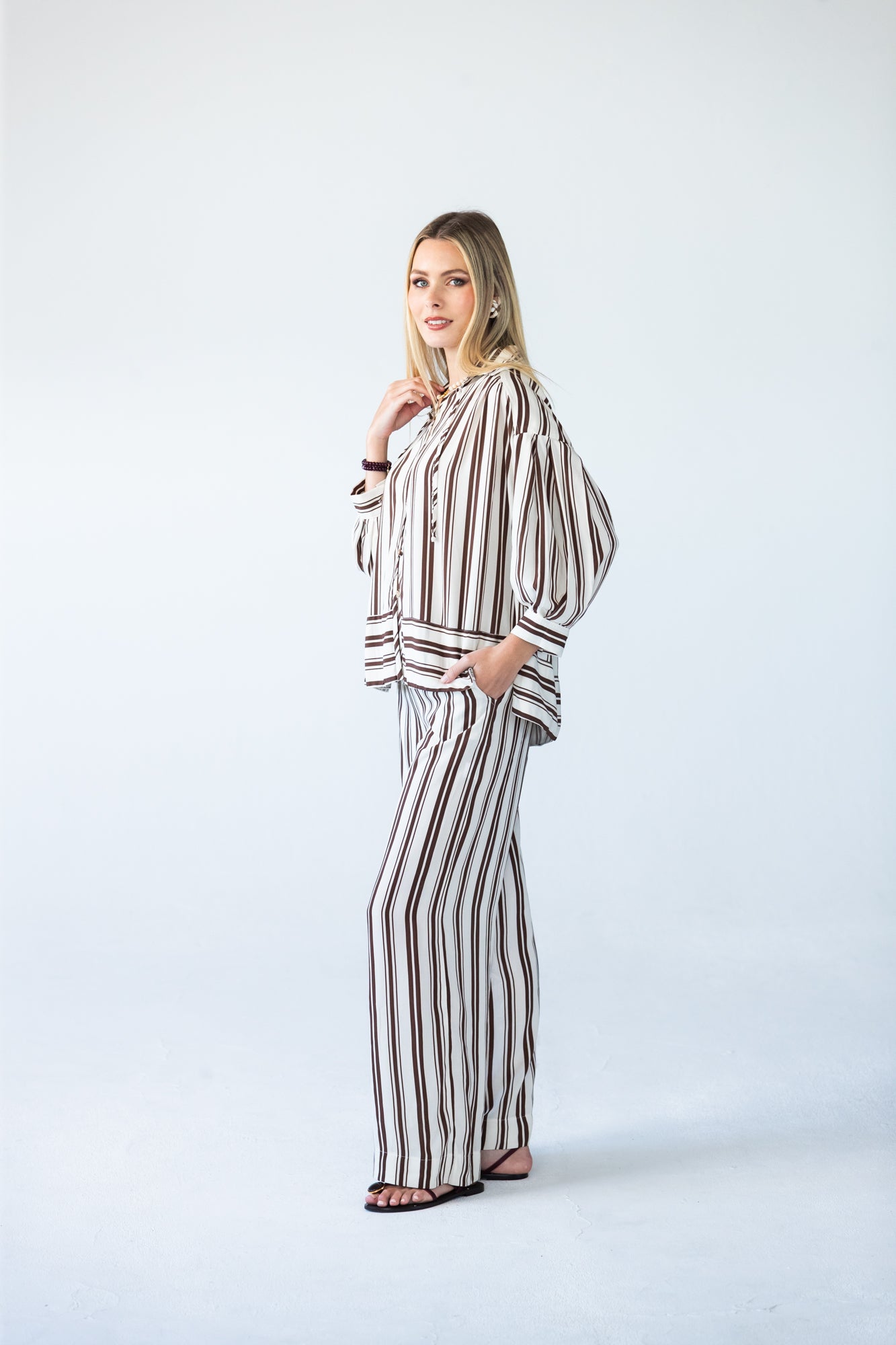 Blake chocolate stripe shirt, side profile view full length