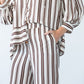 Sydney chocolate stripe wide leg pants, close up front view with hand in pocket