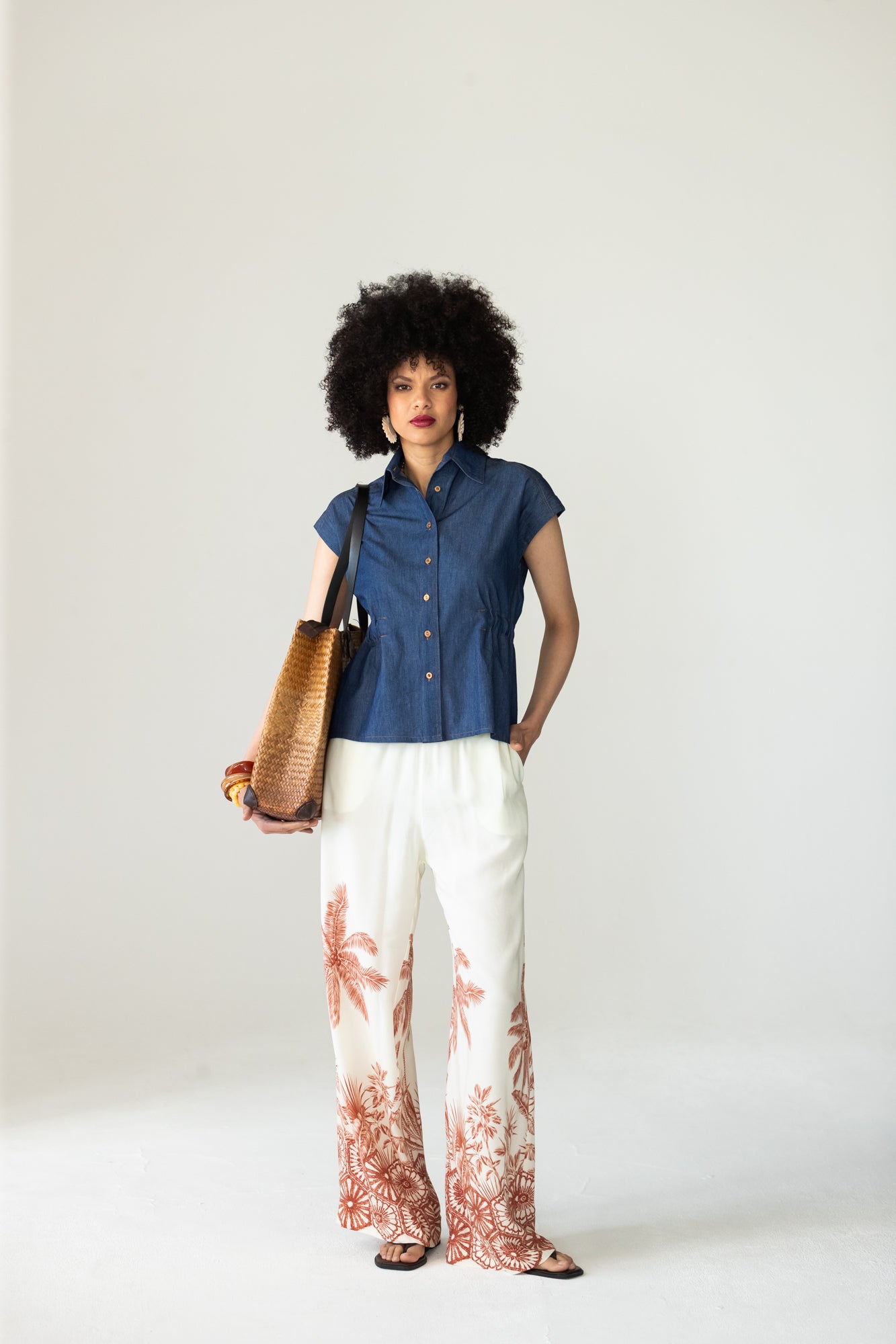 Reese denim shirt, front view styled with palm print wide-leg trousers