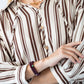 Blake chocolate stripe shirt, close up of neckline with hand at collar