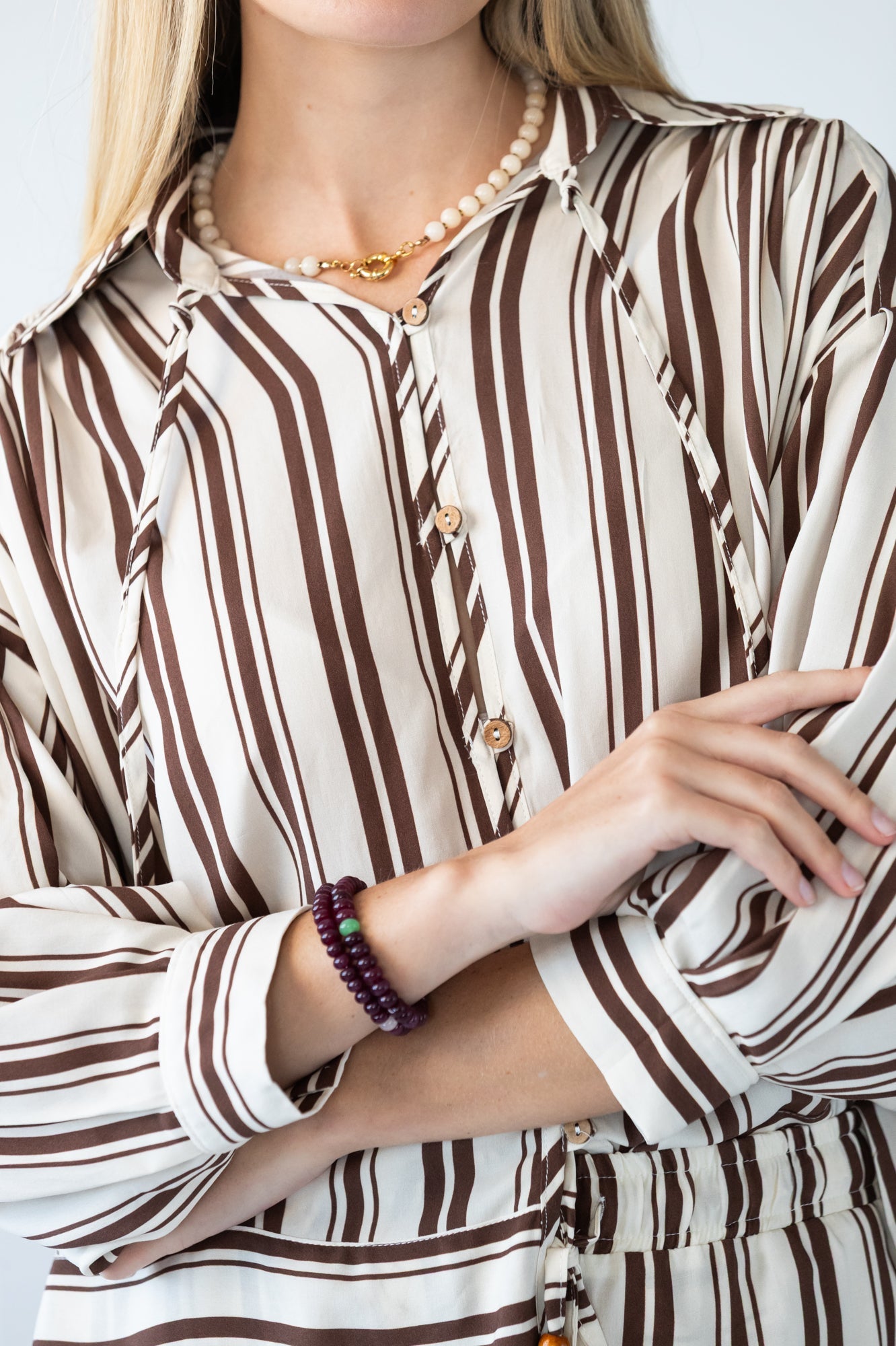 Blake chocolate stripe shirt, close up of neckline with hand at collar
