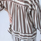 Blake chocolate stripe shirt, back view with hand on hip