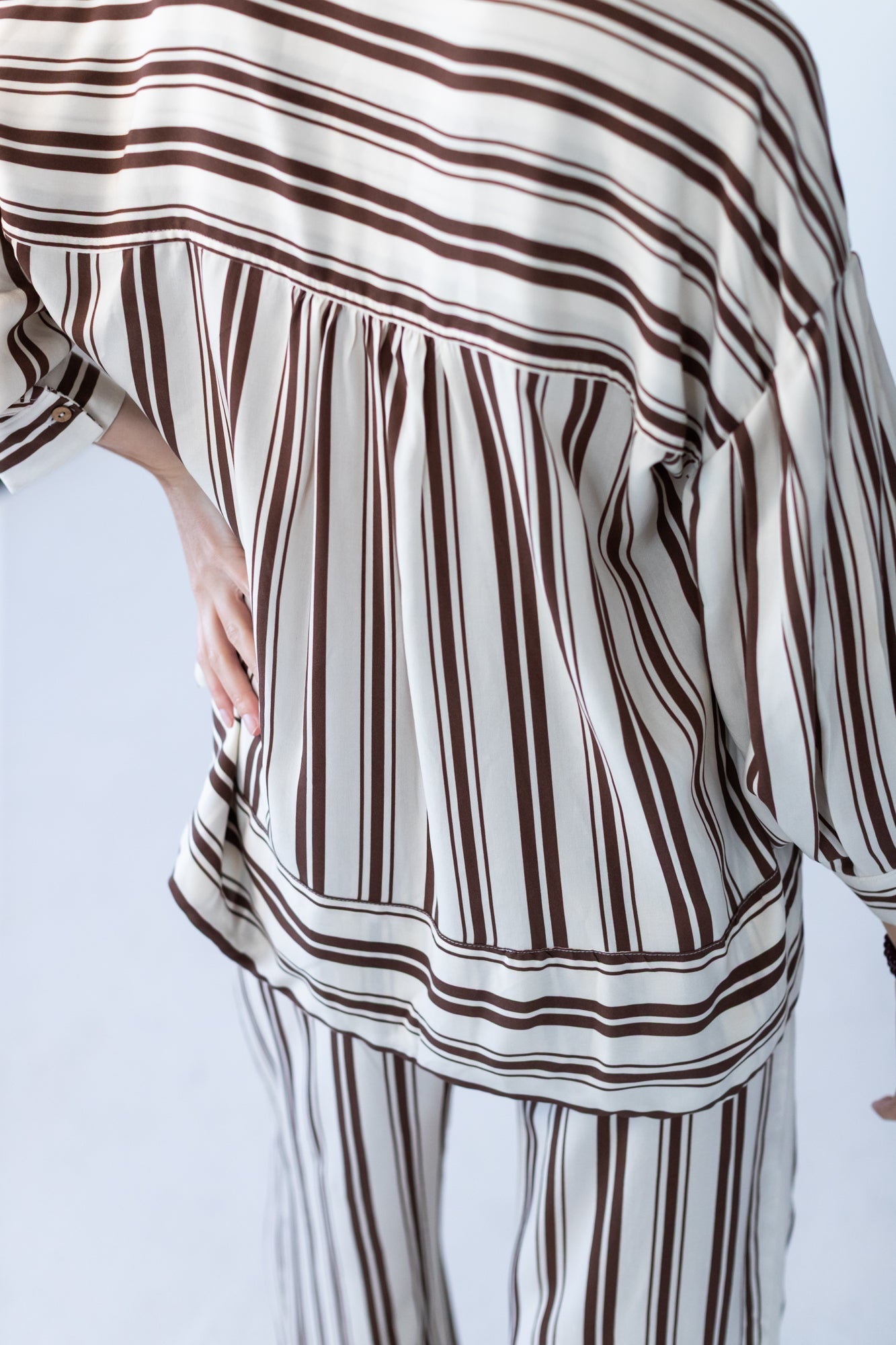 Blake chocolate stripe shirt, back view with hand on hip