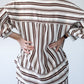 Blake chocolate stripe shirt, back view with hands at waist