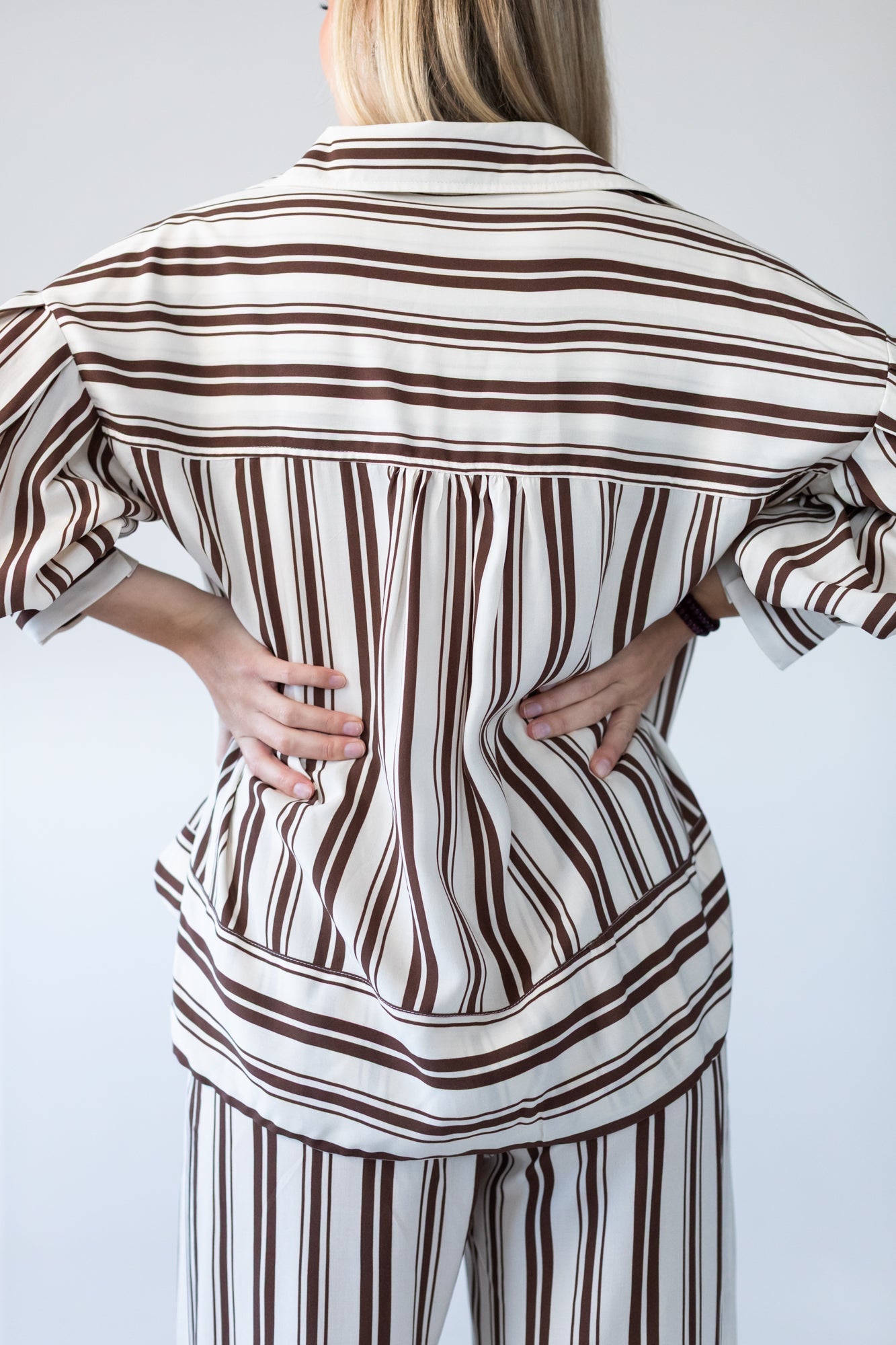 Blake chocolate stripe shirt, back view with hands at waist