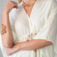 Georgia cream palm print kaftan, close up of neckline and beaded tie