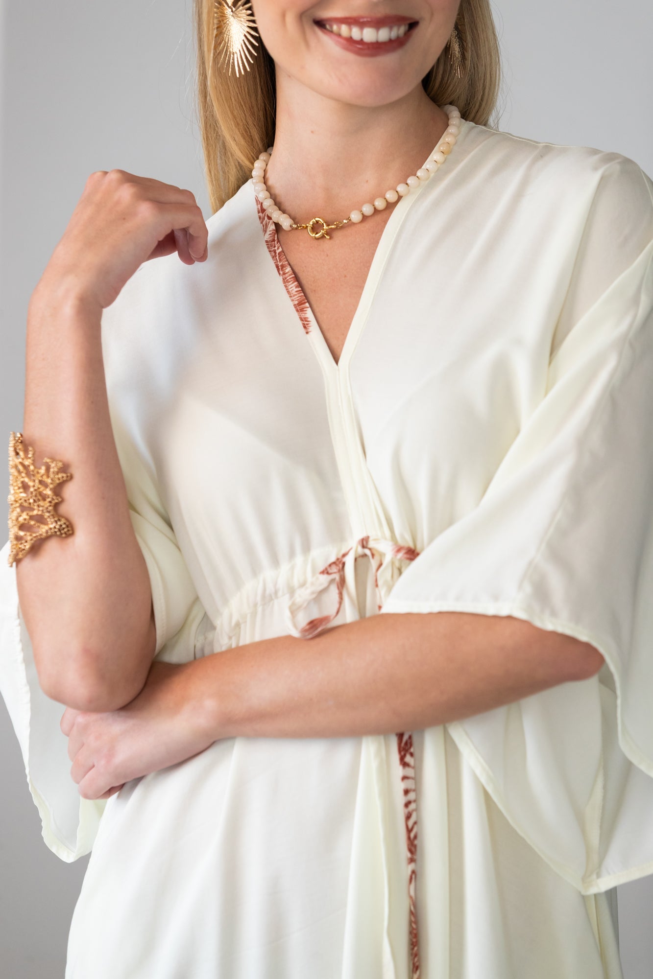 Georgia cream palm print kaftan, close up of neckline and beaded tie