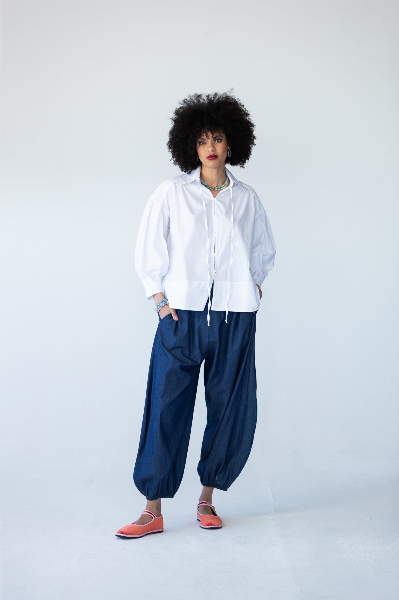 Blake white poplin shirt, front view styled with balloon pants and red shoes
