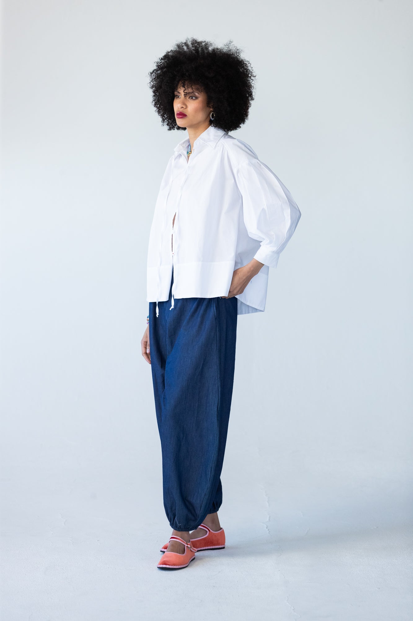 Blake white poplin shirt, side profile view styled with balloon pants
