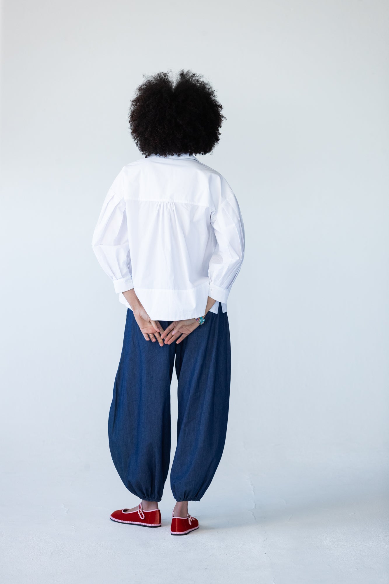 Blake white poplin shirt, back view with hands behind back