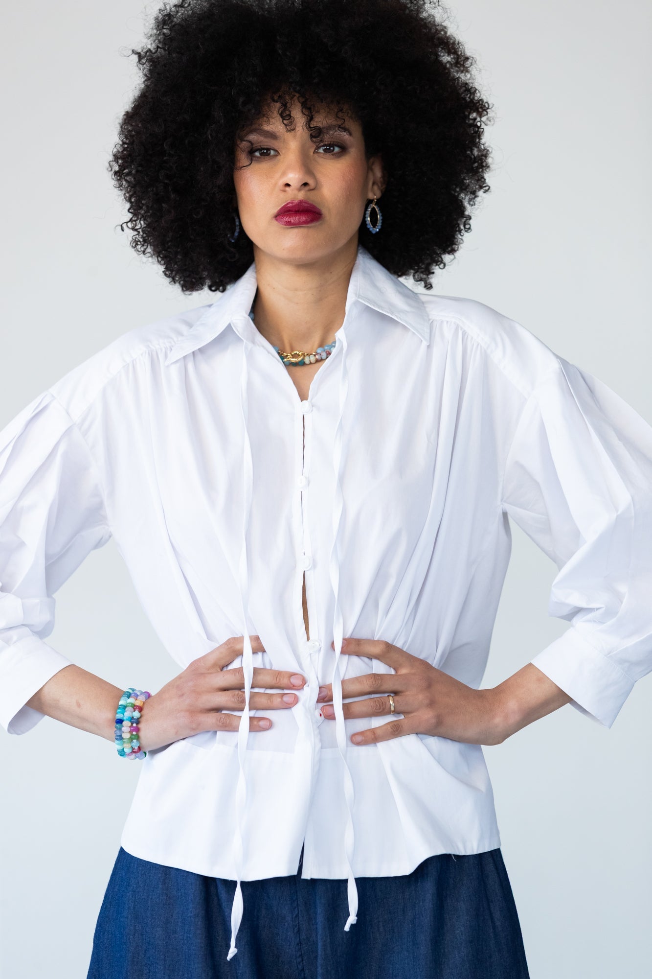 Blake white poplin shirt, front view with hands at waist