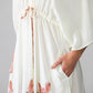 Georgia cream palm print kaftan, close up of pocket with hand inside