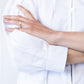 Blake white poplin shirt, close up of cuff with arms crossed