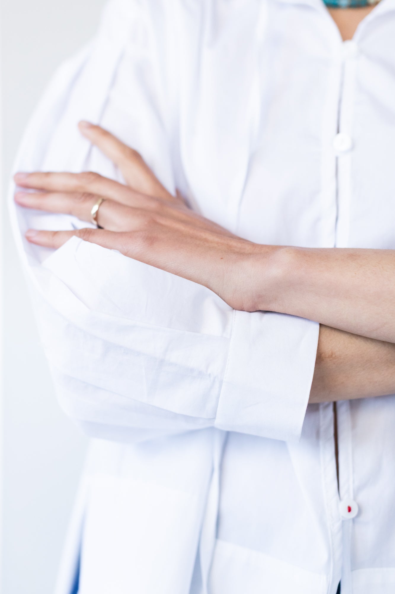 Blake white poplin shirt, close up of cuff with arms crossed