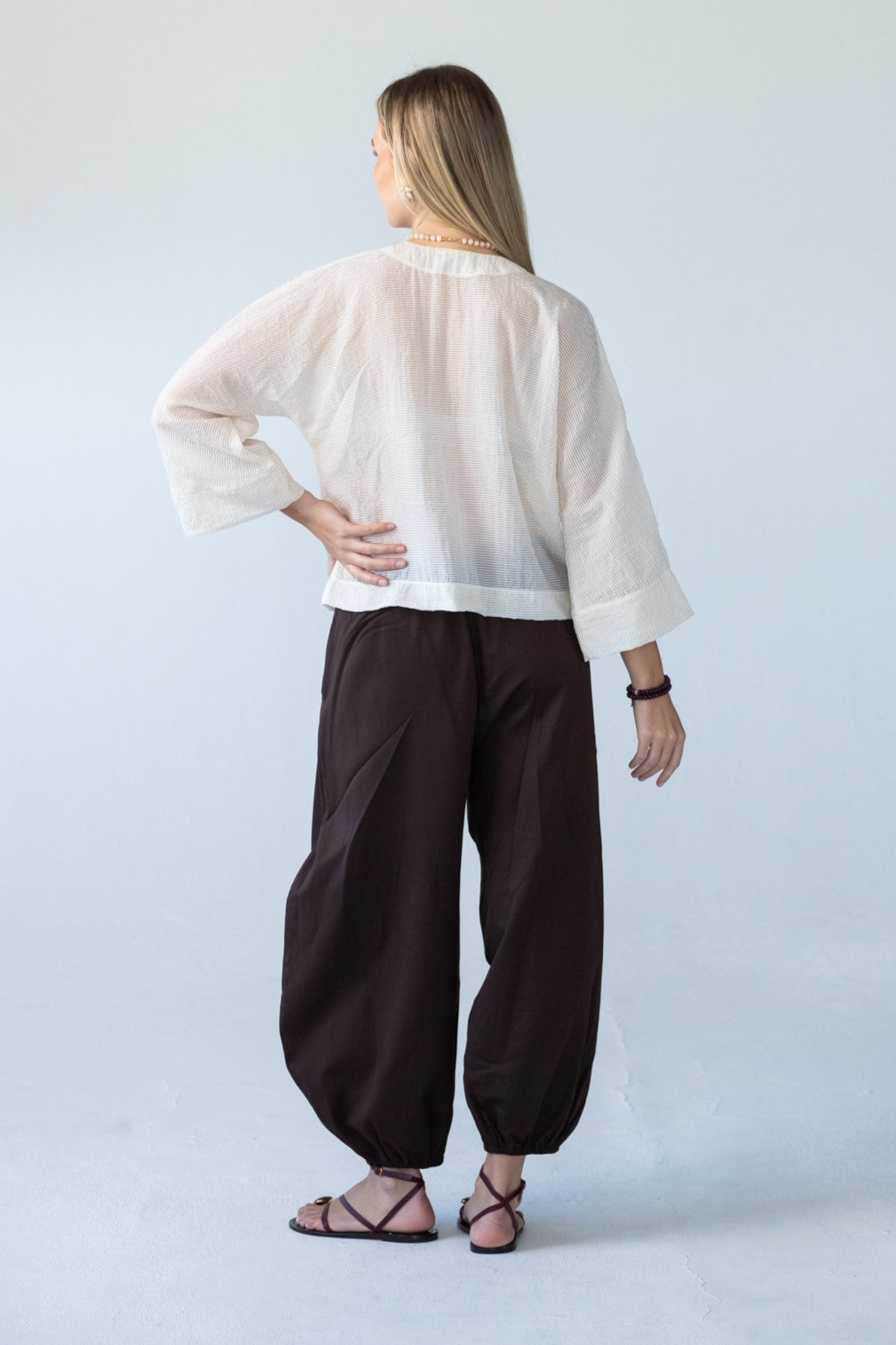 Amelia milk relaxed shirt, back view styled with Stella Balloon Pants in Chocolate