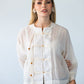 Amelia milk relaxed shirt, front view close up styled with black pants