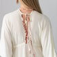 Georgia cream palm print kaftan, close up of back tie with beaded ends