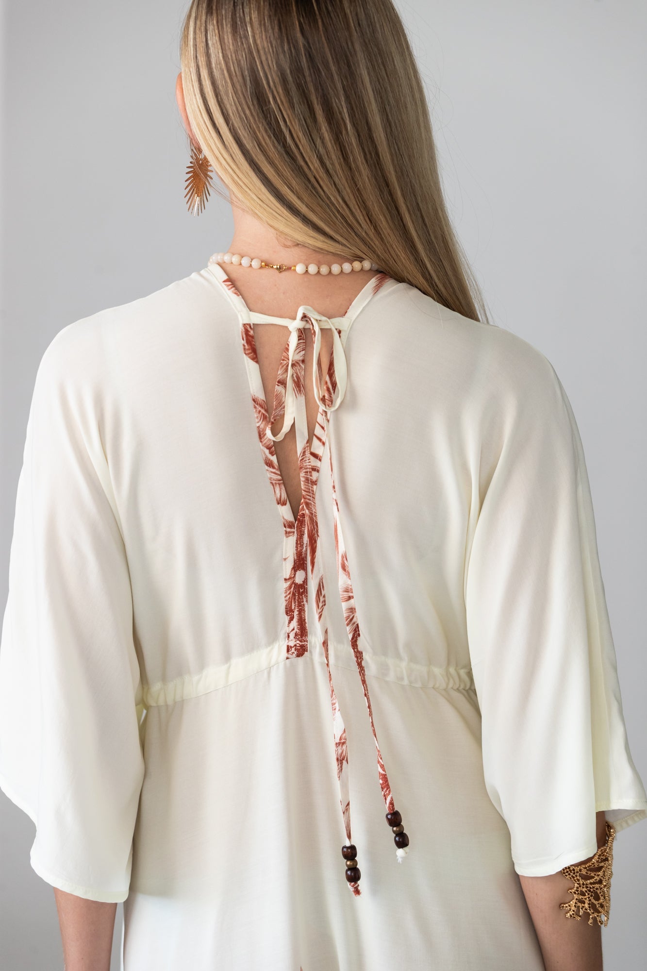 Georgia cream palm print kaftan, close up of back tie with beaded ends