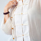 Amelia milk relaxed shirt, close up of button stand and toggle closures