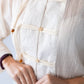 Amelia milk relaxed shirt, close up detail of button stand and toggle closures